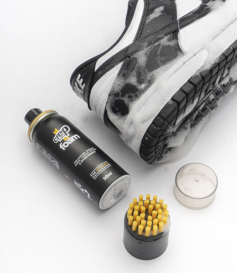 Foam cleaner positioned next to a sneaker, ready for effective cleaning.