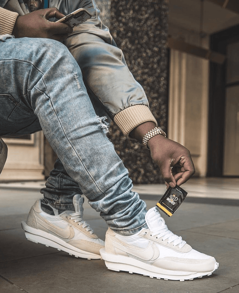 Man holding sneaker cleaning wipes in his hand, ready to use for convenient shoe maintenance